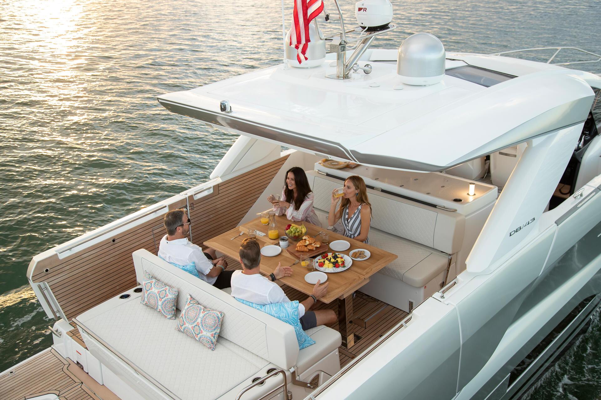 Family dining experience on yacht deck at golden hour